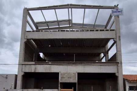 Edificação de múltiplos pavimentos em concreto pré-fabricado, com placa da Novo Horizonte